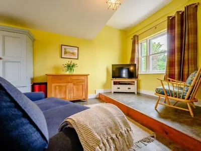 a living room with a blue couch and a tv at 2 Bed in Egremont 87227 in Egremont