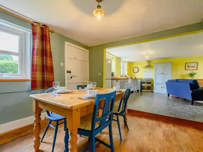 a dining room and living room with a table and chairs at 2 Bed in Egremont 87227 in Egremont