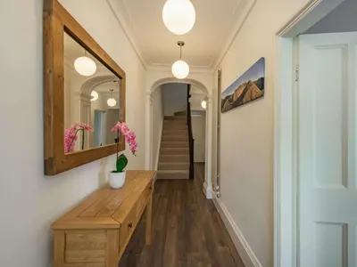 a hallway with a wooden table and a mirror at 4 Bed in Keswick oc-87567 in Keswick