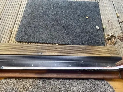 a black rug sitting on top of a wooden floor at Alder Lodge with Hot-tub in Carlisle