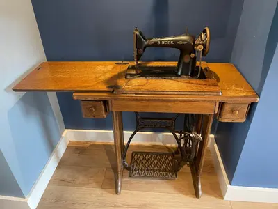 a sewing machine sitting on top of a wooden table at The Ship Inn's Mill Cottage - Weavers Way in Gatehouse of Fleet