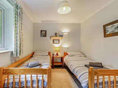 two twin beds in a room with a window at 3 Bed in Threlkeld SZ047 in Threlkeld