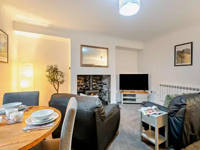 a living room with a table and a television at 1 Bed in Rosthwaite 86395 in Rosthwaite