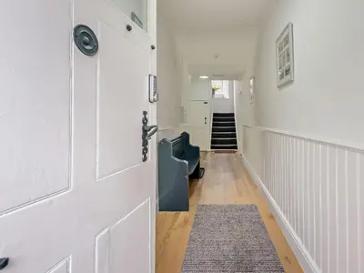 a hallway with a white door and a rug at 1 Bed in Rosthwaite 86395 in Rosthwaite