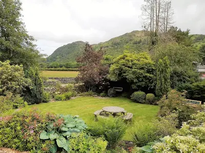 a picnic table in the middle of a garden at 1 Bed in Rosthwaite 86395 in Rosthwaite
