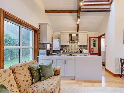 a living room with a couch and a kitchen at 1 Bed in Keswick SZ516 in Keswick
