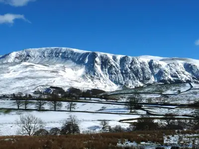 a mountain covered in snow with trees in the foreground at 2 Bed in Keswick oc-sz006 in Keswick
