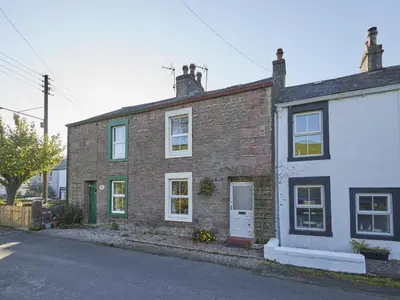 a brick house on the side of a street at 3 Bed in Ullock SZ043 in Arlecdon