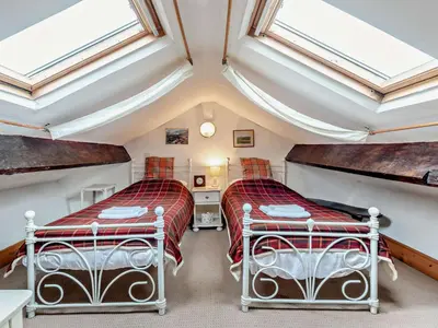 two beds in a attic bedroom with skylights at 3 Bed in Ullock SZ043 in Arlecdon