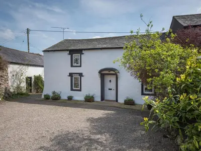 a white house with a door and a gravel driveway at 3 Bed in Pardshaw SZ419 in Dean