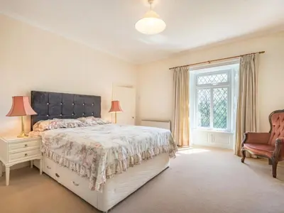 a bedroom with a bed and a chair and a window at 3 Bed in Pardshaw SZ419 in Dean