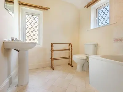 a bathroom with a sink and a toilet and a tub at 3 Bed in Pardshaw SZ419 in Dean