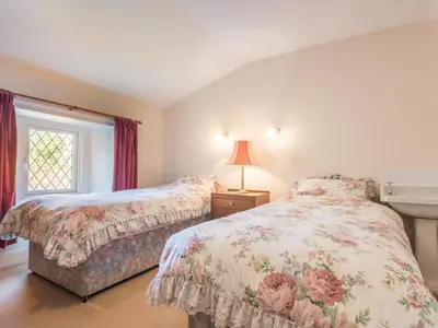 a bedroom with two beds and a window at 3 Bed in Pardshaw SZ419 in Dean