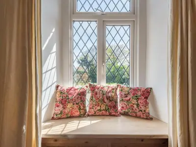 a window seat with pillows in front of a window at 3 Bed in Pardshaw SZ419 in Dean