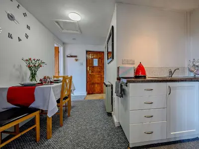 a kitchen with a table and a dining room at 1 Bed in Troutbeck SZ254 in Troutbeck