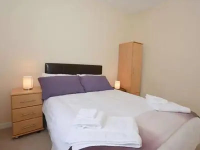 a bedroom with a bed with two towels on it at Criffel View in Dumfries