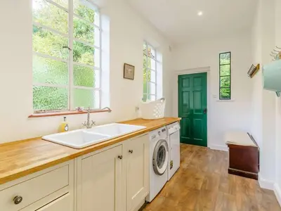 a kitchen with a sink and a washing machine at 6 Bed in Keswick oc-89309 in Applethwaite