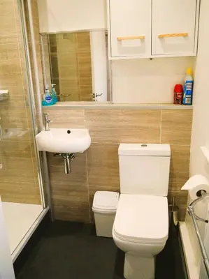 a bathroom with a toilet and a sink at Tom's Place in Kirkcudbright