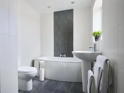 a bathroom with a toilet and a tub and a sink at 2 Bed in Cockermouth SZ282 in Cockermouth