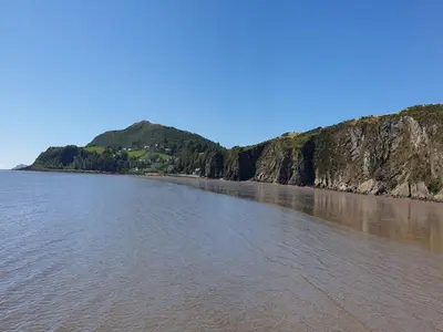 a large body of water next to a mountain at 1 Bed in Sandyhills 85904 in Fairgirth