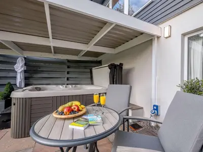 a table with a bowl of fruit and drinks on a patio at 1 Bed in Sandyhills 85904 in Fairgirth