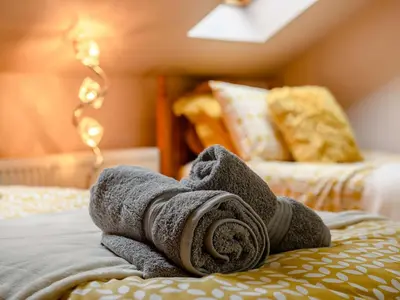 a rolled up towel laying on a bed at 2 Bed in Portinscale 89261 in Portinscale