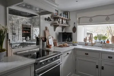 a kitchen with a sink and a stove top oven at The Little Cottage in Chapel Stile