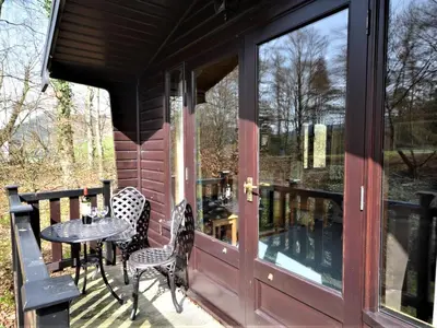 a screened in porch with a table and chairs at 1 Bed in Keswick oc-82550 in Keswick