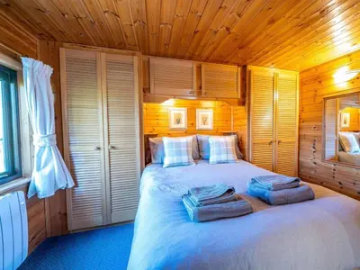 a bedroom with a large bed with towels on it at 1 Bed in Keswick oc-82550 in Keswick