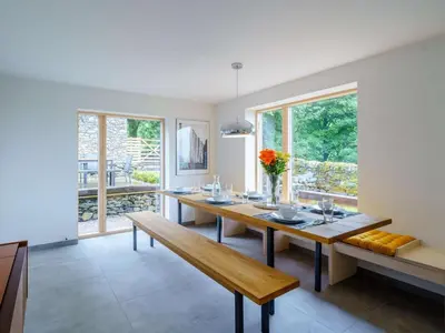 a dining room with a wooden table and benches at 3 Bed in Matterdale oc-83002 in Dockray