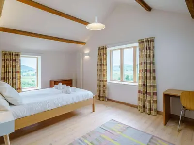a bedroom with a bed and two windows at 3 Bed in Matterdale oc-83002 in Dockray