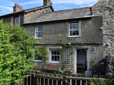 an old stone house with a wooden fence at 3 Bed in Holmrook oc-sz313 in Boot