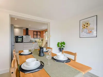a dining room with a table and a kitchen at 3 Bed in Kippford 88274 in Kippford