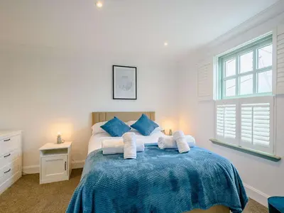 a bedroom with a bed with towels on it at 3 Bed in Kippford 88274 in Kippford
