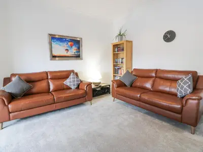 two brown leather couches in a living room at Little Ireland in Stranraer