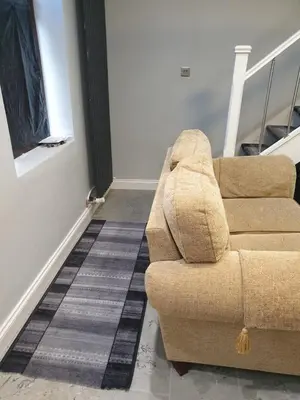 a brown couch sitting in a living room at A Whole Terrace house to you in Distington