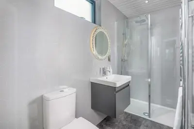 a bathroom with a toilet and a sink and a shower at Crocus Penruddock, dog & eco friendly lodge with hot tub in Penruddock