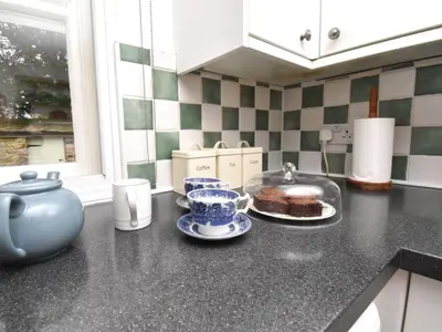 a kitchen with a counter top with a cake on a plate at 2 Bed in Caldbeck SZ212 in Caldbeck