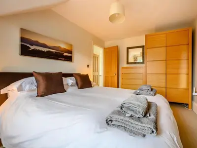 a bedroom with a white bed with towels on it at 4 Bed in Keswick oc-89258 in Keswick