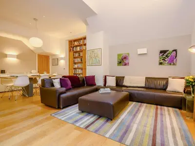 a living room with a leather couch and a table at 4 Bed in Keswick oc-89258 in Keswick