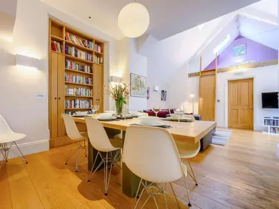 a living room with a dining room table and chairs at 4 Bed in Keswick oc-89258 in Keswick