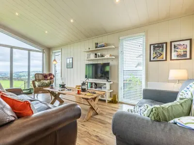 a living room with two couches and a table at 2 Bed in Caldbeck 80563 in Caldbeck