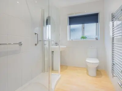 a bathroom with a shower and a toilet and a sink at 2 Bed in Portinscale SZ071 in Portinscale