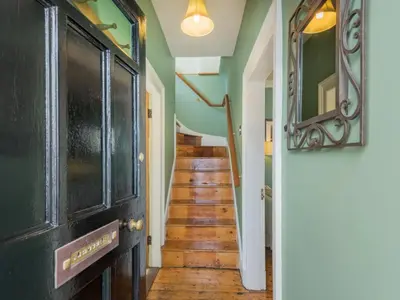 a hallway with wooden floors and green walls at 2 Bed in Keswick oc-sz126 in Keswick