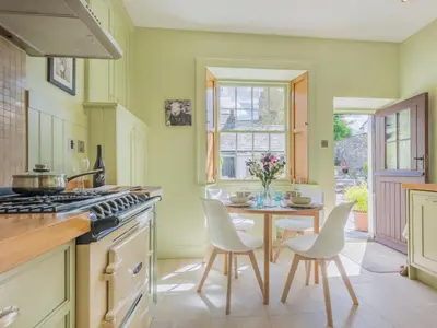 a kitchen with a table and chairs and a window at 2 Bed in Keswick oc-sz126 in Keswick