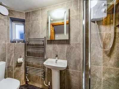 a bathroom with a sink and a toilet and a mirror at 1 Bed in Rosthwaite 86245 in Rosthwaite