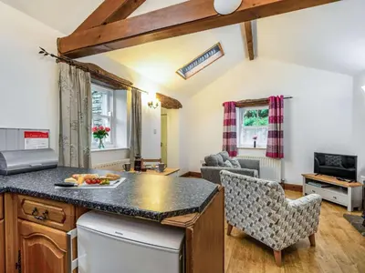 a kitchen with a counter top and a living room at 1 Bed in Rosthwaite 86245 in Rosthwaite
