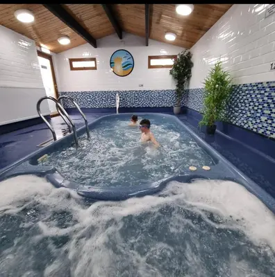 two children swimming in a swimming pool at Port Carlisle Caravan near Bowness on Solway in Carlisle