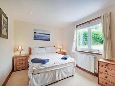 a bedroom with a bed with two night stands and a window at 1 Bed in Balmaclellan CA371 in Castle Douglas