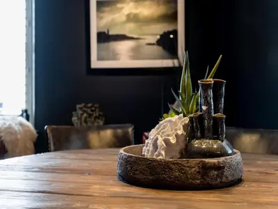 a wooden table with a plant in a bowl on it at 3 Bed in Portpatrick 77308 in Portpatrick